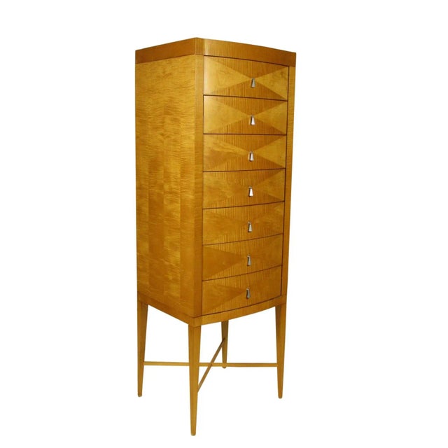 A Modern seven (7) drawer tiger maple bow-front chest by Baker with original nickel plated brass pulls and solid oak...