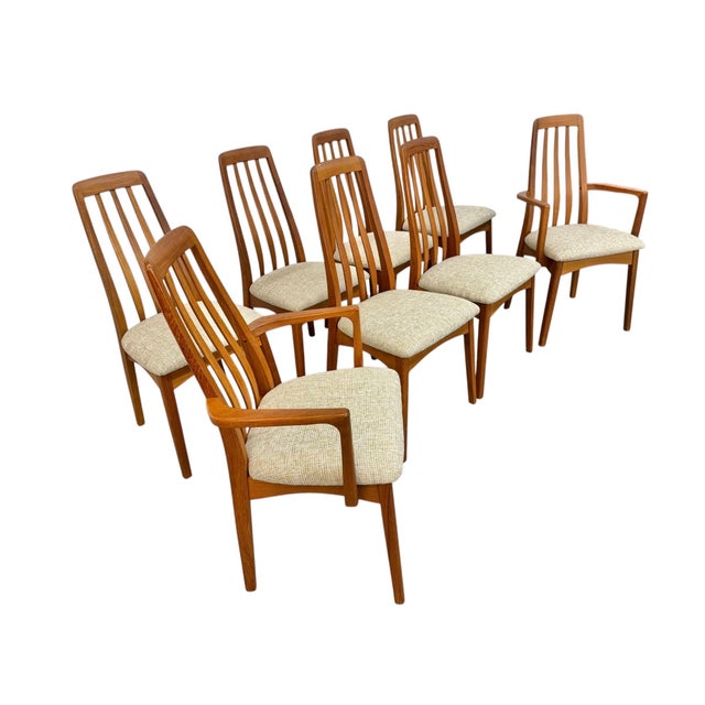 Elevate your dining space with this exceptional set of vintage Danish Modern “Eva” style dining chairs, crafted in warm...