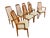 Elevate your dining space with this exceptional set of vintage Danish Modern “Eva” style dining chairs, crafted in warm...