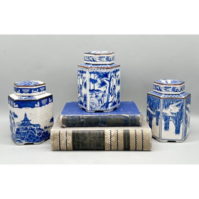 Charming vintage set of three blue and white porcelain tea caddies, each featuring a hexagonal form and beautifully hand-...