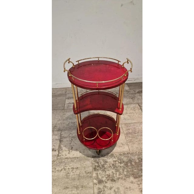 Italian Red Parchment Round Serving Trolley with Brass Details attributed to Aldo Tura, 1970s, in Very Good conditions....