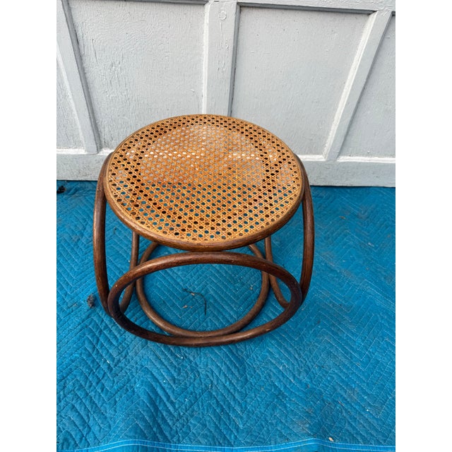Vintage Bentwood Cane Stool Charming mid-century style bentwood stool featuring a classic round cane seat and continuous...