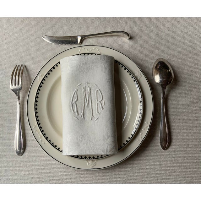 A distinguished set of six antique French linen dinner napkins showcasing the emerging Art Deco aesthetic of the early...