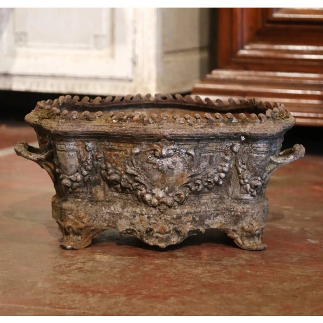 Rich in sculptural detail and antique character, this French Rococo jardinière features an ornate oval form with...