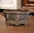Rich in sculptural detail and antique character, this French Rococo jardinière features an ornate oval form with...