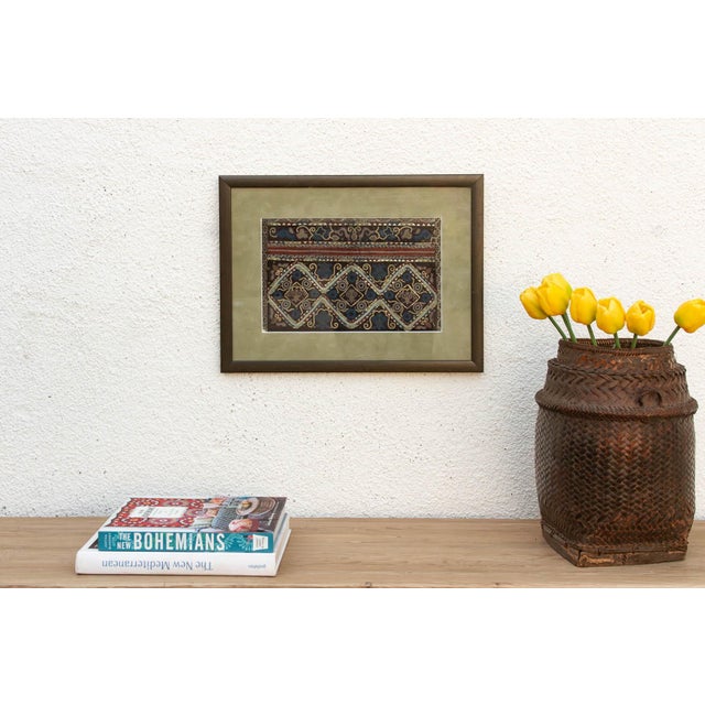 This diamond trellis embroidery is a high-contrast study in traditional geometric artistry. This vintage textile fragment...