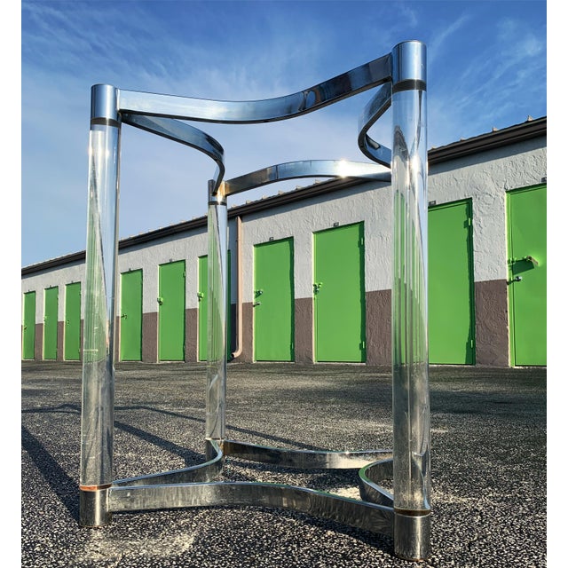 Beautiful chrome and Lucite dining table base in a star pattern. Four cylindrical Lucite tubes supported by top and bottom...
