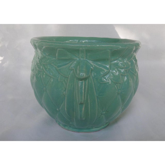 A lovely midcentury McCoy cachepot/planter in a diamond quilted pattern with a laurel leaf garland under the top rim and...
