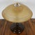 An art deco table lamp with brown bakelite stem and circular stepped bakelite base. Original tinted bakelite shade with a...