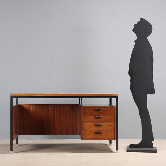 Vintage desk with four drawers, mahogany veneer with polyester finish, lacquered metal frame with brass feet. This piece...