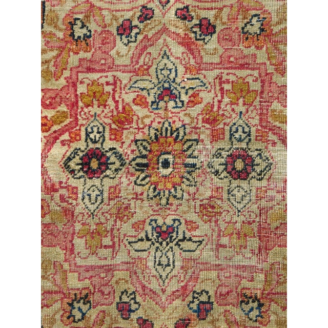 Geometric central medallion contained within a large pronounced medallion. Soft earth tones. Floral decorated light...