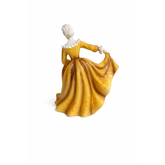 A beautiful vintage Royal Doulton figurine titled “Kirsty” (HN2381), designed by celebrated Royal Doulton artist Peggy...