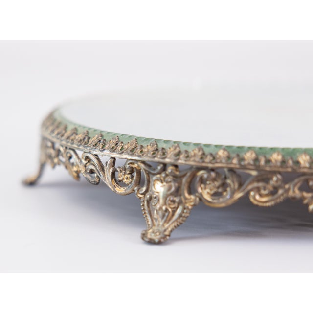 A lovely antique French gilt brass ormolu mirror plateau, circa 1920. This beautiful plateau has ornate scrolls in a...