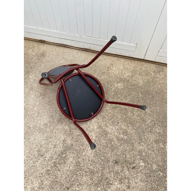 64 identical chairs available for sale Burgundy metal frame chair Seat and back covered in foam and gray fabric Very solid...