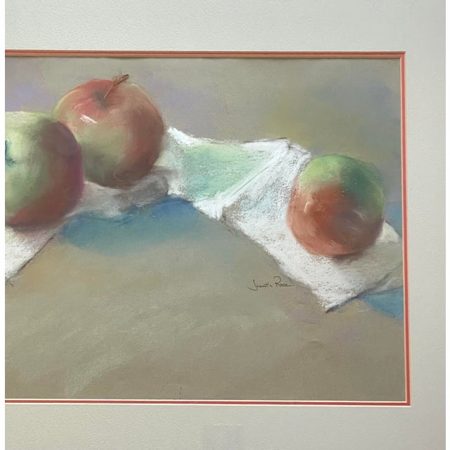 This vintage pastel still life of red apples features a charming matted and framed artwork by artist Jeanette Rose. The...