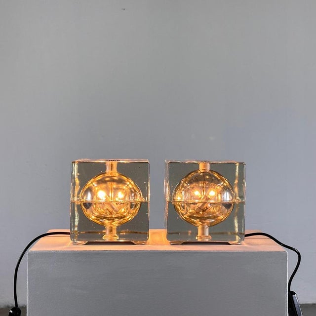 Illuminate your space with iconic mid-century charm embodied in this remarkable pair of Cubosfera table lamps, designed by...
