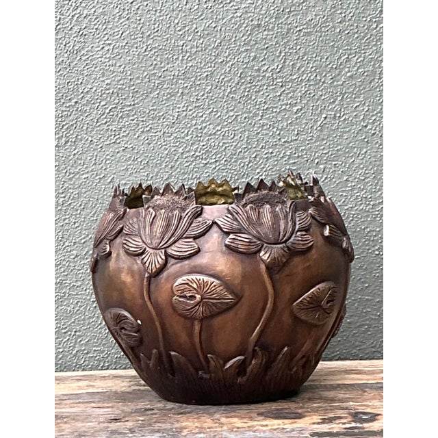 This sculptural vintage brass bowl captures the serene beauty of a water garden with its exquisite high-relief lotus...