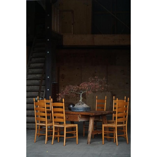 A beautifully crafted set of eight Italian ladder-back dining chairs from the 1960s. These chairs are made from solid...