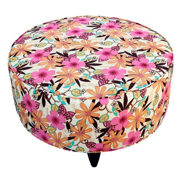 Playful round stool/ottoman upholstered in a vibrant flower, power floral print the colorful fabric captures the spirit of...