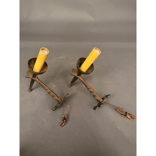 Pair of French hand-forged iron wall sconces dating to circa 1890. Each sconce features an interesting twisted stem and a...