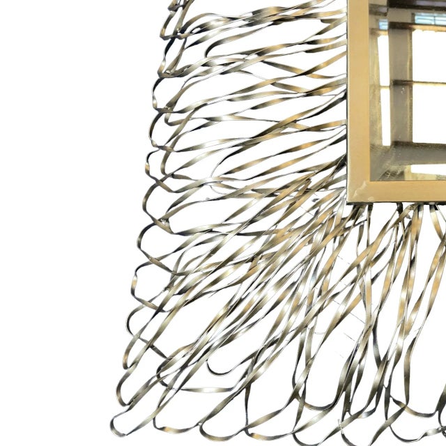 This mirror by Uttermost exudes luxuriousness. It has a forged metal frame with a silver finish and soft champagne accents...