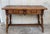 About An 19th century Spanish baroque desk, or writing table made of solid oak with fluted shaped legs joined by solid...