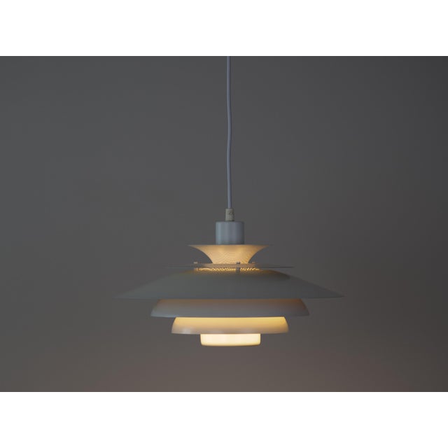 This lamp was designed by Danish designer Kurt Wiborg and manufactured by Jeka. The lamp's form is based on the principle...