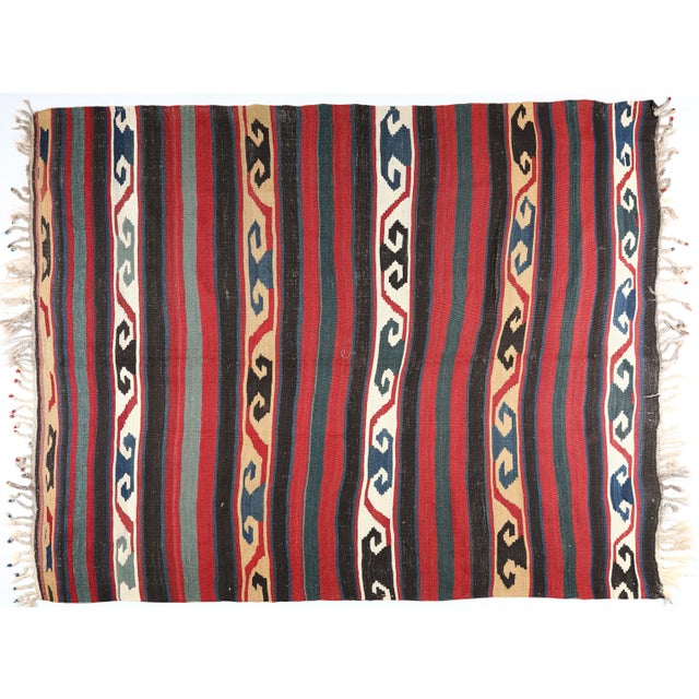 This handwoven Shirvan Kazak kilim is a remarkable example of Caucasian textile artistry from the late 19th to early 20th...