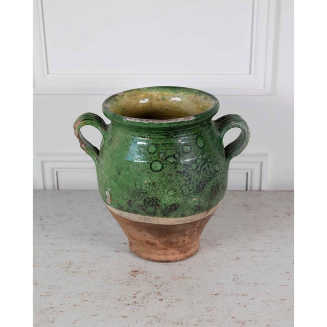 A product of French provincial pottery, this confit pot was made around 1840 and carries a green glaze across its upper...