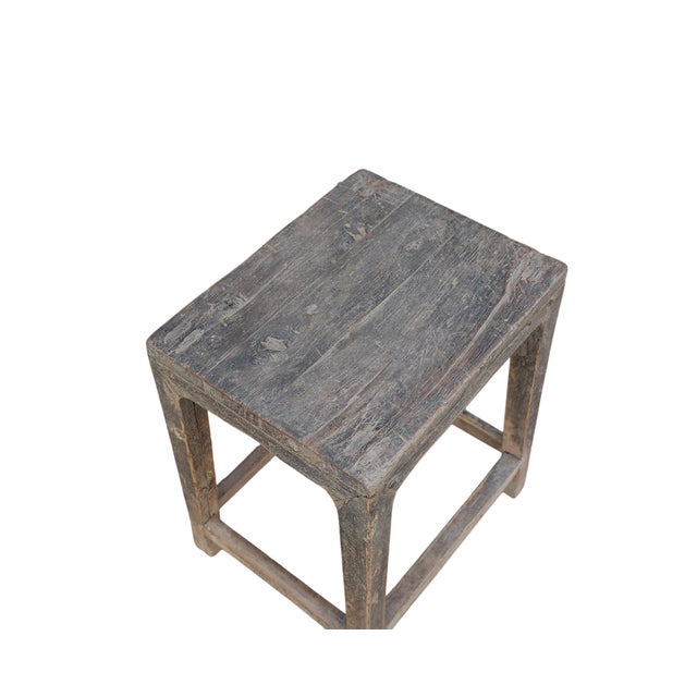 Antique Chinese Elm Stool or Tea Table, in an old natural elm finish, with slight hoof foot, lower leg supports, and...