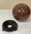 Vintage large marble ball sphere orb on lacquered wood display stand. The marble is chestnut brown with caramel/amber,...