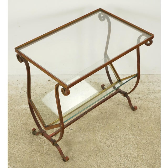 1950s Mid Century style rectangle shaped end table with a magazine storage area. It is made of an worn dark gilded finish...