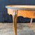 Elegant antique French Louis XV marble-top table featuring an oval inset marble top framed by richly figured walnut and...