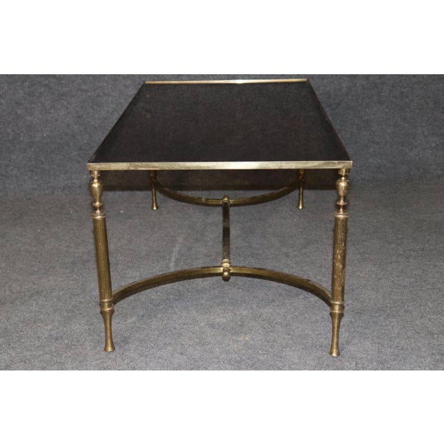 A superb solid brass coffee table dating to the 1960s, designed in the sophisticated French neoclassical manner closely...