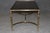 A superb solid brass coffee table dating to the 1960s, designed in the sophisticated French neoclassical manner closely...