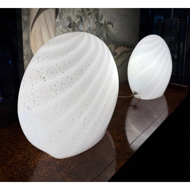 Pair of Blown Oblate Spheroid Swirled Murano Glass Lamps with Silver inclusions Offered for sale is a pair of vintage...
