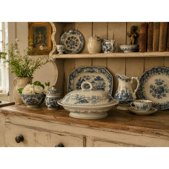 A beautifully aged antique covered dish in classic blueish gray‑and‑white transfer style, featuring scrolling florals,...