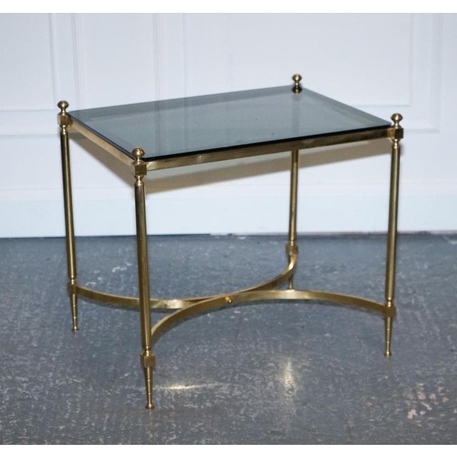 Hollywood Regency Brass & Smoked Glass Coffee Table. A French Hollywood Regency 1960s brass and smoked glass coffee table...