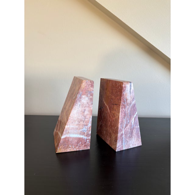 A striking pair of vintage-style natural stone bookends featuring a beautiful blend of warm rose, terracotta, dusty mauve,...