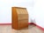 Discover a beautiful small teak secreataire that perfectly embodies the elegance and functionality cherished by Mid...