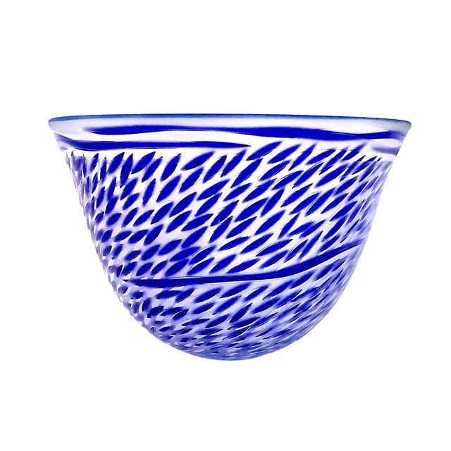This striking vessel is an Engebretson and Nielsen art glass bowl featuring a dense pattern of cobalt blue, almond-shaped...
