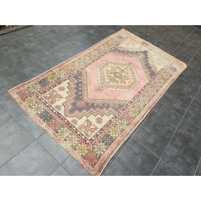 This is a vintage Turkish Oushak rug from the 1960s. The piece was hand-knotted.
