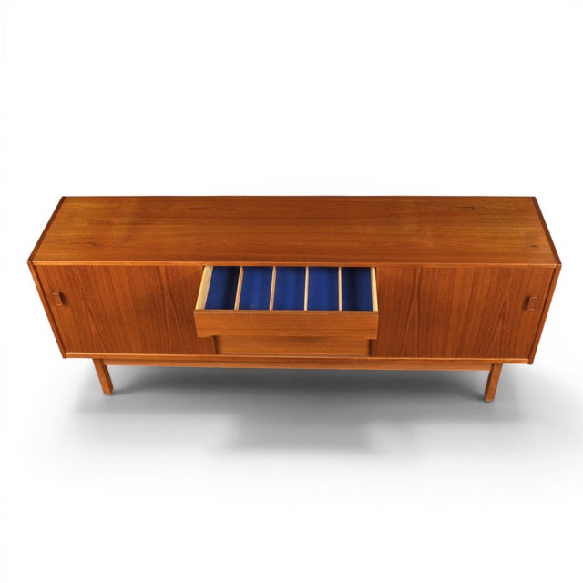 Produced by Troeds Bjärnum of Sweden during the firm's most celebrated decade, this teak credenza exemplifies the...