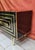 Splendid piece of furniture entirely in black glass with brass finishes and handles Brass may have a patina, but it is...