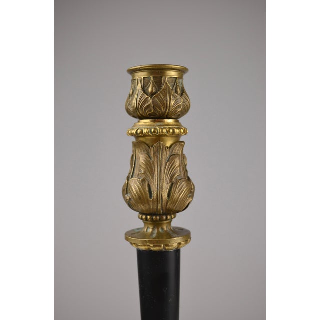 Elegant pair of late 19th century French candlesticks crafted in finely chased gilt bronze and black marble. These refined...