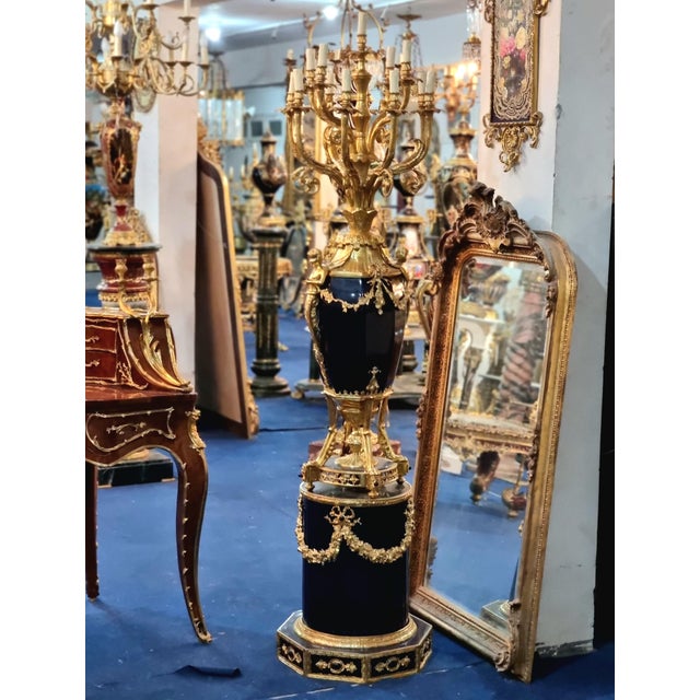 Make a dramatic statement with this extraordinary decorative ensemble, featuring a deep midnight-blue porcelain vase...