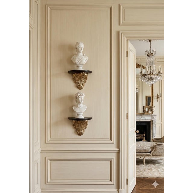 A refined pair of vintage decorative wall brackets (shelves) featuring sculptural shell-form brass corbels with black wood...