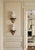 A refined pair of vintage decorative wall brackets (shelves) featuring sculptural shell-form brass corbels with black wood...