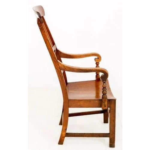 Highly Unusual Elm Country Chair. Standing on square tapered legs with an "H" frame. The Arms are supported by ring turned...