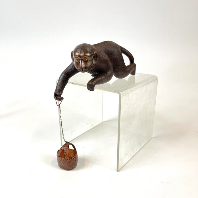 What a fun little guy! This ceramic monkey with a ceramic hanging basket peers over any flat surface. The metal chain...